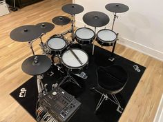 a drum set sitting on top of a black rug