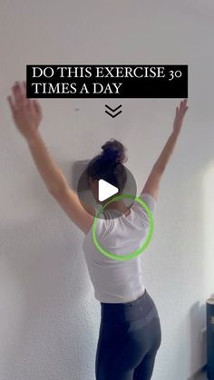 a woman standing in front of a white wall with her arms up and the words do this exercise 30 times a day