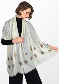 Woven from a very fine cashmere, this elegant ivory scarf is elevated by a hand-embroidered earings design in metallic beads from both ends. Incredibly stylish and comfortably warm for year-round wear, this scarf can be styled in many eye-catching ways, especially as an exclusive accessory to a wedding gown. Luxury Embroidered Scarves For Eid, Elegant Embellished Cream Dupatta, Elegant Pashmina Shawl With Intricate Embroidery, Elegant Embroidered Pashmina Shawl, Elegant Dupatta With Gold Embroidery, Elegant Cashmere Shawl, Festive White Shawl With Intricate Embroidery, Elegant Winter Festive Pashmina Shawl, Elegant Cream Dupatta With Pearl Embroidery