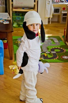 a little boy dressed in a dog costume