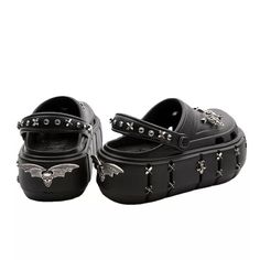 Revitalize your inner goth with Batty Goth-crocs! These chic and fierce crocs showcase an exclusive bat design that will capture attention. Embrace the ease and functionality of crocs while making a daring statement. Ideal for any goth or non-conformist with an appreciation for style. Step into bold and edgy style with these exclusive Batty Goth-crocs! Designed to showcase your inner goth, these crocs are perfect for making a statement and turning heads. And with the comfortable and practical functionality of crocs, you can express your unique style and stand out from the crowd. Whether you're a goth or just someone who loves to make a bold statement, these crocs will elevate your fashion game. Platform Slip Ons, Bat Design, Women's Slip Ons, Black Grunge, Funky Shoes, Edgy Style, New Rock