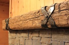 a close up of a piece of wood on top of a fire place with metal straps