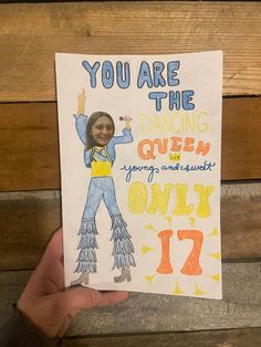 a hand holding up a card that says, you are the dancing queen only 17