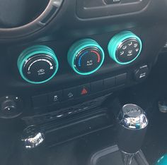 the gauges on the dashboard of a car are blue and black with green trim