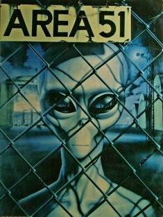 a sign that says area 51 behind a chain link fence with an alien face on it