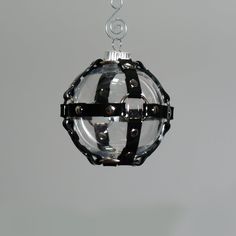 a glass ornament hanging from a metal chain