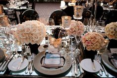 the table is set with flowers and silverware for an elegant wedding reception or special event