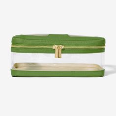 a green and clear bag with gold zippers on the inside, sitting on a white surface