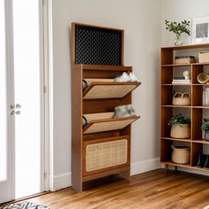 a living room filled with lots of furniture next to a white wall and wooden floors