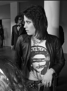 a black and white photo of a man in a leather jacket