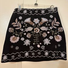 Black Floral Suede Mini Skirt. Size Large. Brand New Embroidered Black Skirt For Summer, Bohemian Black Skirt For Day Out, Chic Black Skirt With Floral Embroidery, Fitted Embroidered Black Mini Skirt, Chic Embroidered Black Skirt, Embroidered Black Mini Skirt For Spring, Floral Wrap Skirt, Blue Jean Skirt, Multicolor Skirt