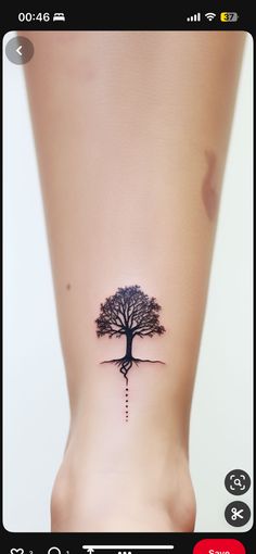 a small tree tattoo on the side of a woman's right leg, with an arrow