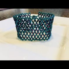 Metallic Teal Seed Beads And Higher Metallic Dragonfly Bugle Beads Are Sewn With Needle And Beading Thread To Create This Netted Cuff. Teals And Purples Reflect Off This Very Shiny Bracelet Just Like A Mermaid’s Tail. This Bracelet Will Fit A 7 Inch Wrist But Does Have Some Stretch Because Of The Netted Construction. Grab This Beauty Before It’s Gone. The Pictures Don’t Give The Shine Of This Bracelet Justice. Follow Me On Fb @Jessica.Lawrull Or On Ig @Shopsteviejewelsbyjessica Beaded Bracelet N Handmade Blue Cuff Bracelet For Party, Netted Bracelet, Mermaid Glass Bracelet, Mermaid Glass Beads, Shiny Bracelets, Masquerade Party, Bugle Beads, Womens Jewelry Bracelets, Cuff Bracelet