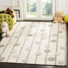 a white rug with grey circles on it and two teddy bears sitting in the corner