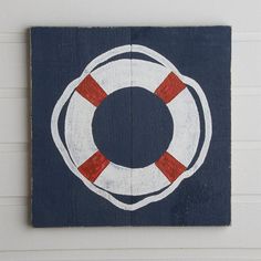 a wooden sign with a life preserver painted on it