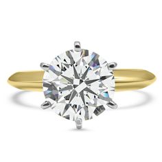 a yellow gold ring with a round cut diamond