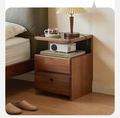 a nightstand with a camera on top of it