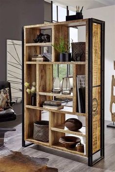 an open bookcase with many books on it in a room filled with furniture and decor