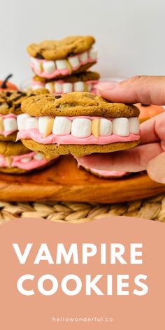 two hands holding cookies with marshmallows on them and the words vampire cookies above it