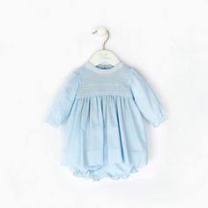 Introducing the Baby Girl Long Sleeve Dress! This beautiful dress is perfect for any special occasion. It is machine washable, so it is easy to care for. The 100% cotton fabric is soft and comfortable, and the hand embroidered pin-tucked design and lace collar add a special touch. The long puffy sleeves and sash in the back make this dress easy to put on and take off, so your little one can be comfortable all day long. The buttons in the back also make it easy to dress up or down depending on your child's needs. Whether you are dressing up for church or just dressing up for fun. This long sleeve dress is the perfect choice! Spring Baptism Dress With Lace Collar, Blue Cotton Dress For Baptism, Classic Cotton Dress With Lace Collar, Light Blue Cotton Baptism Dress, Light Blue Cotton Dress For Baptism, Cotton Smocked Dress With Ruffles For Baptism, Blue Peter Pan Collar Dress For Daywear, Cotton Smock Dress With Peter Pan Collar, Blue Lace Trim Dress For Baptism