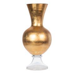 a gold vase sitting on top of a white table