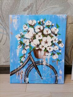 a painting of a bicycle with white flowers in a vase on the front and side