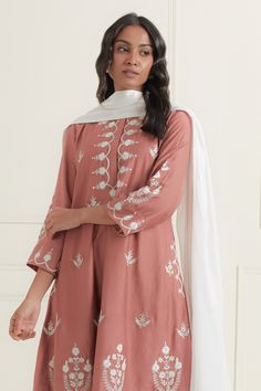 Dusty pink kurta embroidered with white scalloped motifs on border. Comes with plain white pant and plain dupatta.
Components: 3
Pattern: Embroidered
Type Of Work: Floral
Neckline: Round
Sleeve Type: Three quarter
Fabric: Kurta: Chanderi Silk, Pant: Cotton, Dupatta: Kota Cotton
Color: Pink
Other Details: 
Elasticated waistband
Hidden front placket
Flowy kurta silhouette
Occasion: Puja,Mehendi and Haldi - Aza Fashions Kurta Silhouette, Pink Kurta, White Pant, Silk Pant, Scalloped Border, Cotton Dupatta, Fashion App, Plain White, White Pants