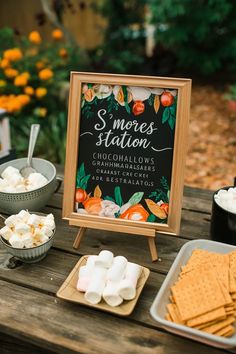 there is a sign that says smores station and marshmallows on the table