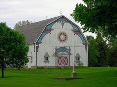 an old white church with a cross on the front