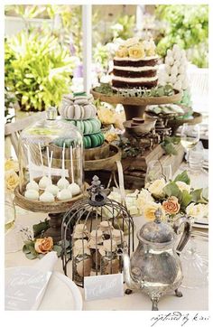 a table topped with lots of cakes and desserts