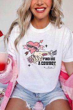 Looking for some love this Valentine's Day? This "Cowboy Valentine" tee features a skeleton hand "shooting" western style jewelry and a playful message: "Cupid, find me a cowboy." Perfect for any quirky cowgirl or cowboy, this white crew neck tee is sure to make a statement. Yeehaw! Cowboy Valentines, Valentine Graphic, Valentines Graphic Tee, Pet Mom, A Skeleton, White Crew Neck, Skeleton Hand, Skeleton Hands, Style Jewelry