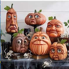 halloween pumpkins with faces on them sitting next to each other