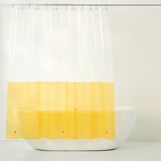 a yellow and white shower curtain in a bathroom