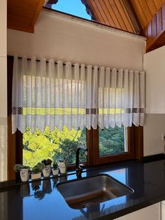 a kitchen with a sink and window in it