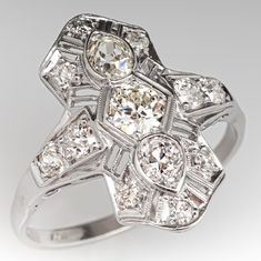 an art deco diamond ring on a white background