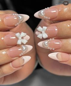 a woman's hands with french manies and white flowers on their fingertipss