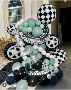 a black and white balloon tree with checkered balloons