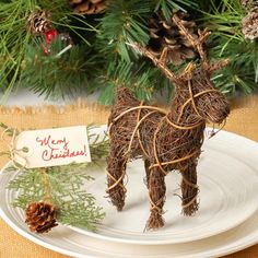 a christmas ornament on a plate with pine cones