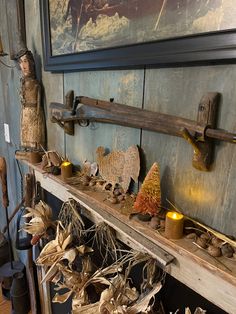 an assortment of items are displayed on a shelf in a room with blue walls and wood paneling