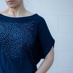 Our original Meteor Shower design has been hand-printed in pale gray water-based ink onto deep navy blue dolman sleeve tops. These shirts have a wide neckline and can be worn off the shoulder. They have a feminine, dramatic drape that tapers down to a fitted hip. FIT & SIZING:- Available in sizes S-2XL- Intended to drape loosely throughout chest and upper body- Tailored for a *SNUG FIT* in the hips- Model shown is 5'8 and a size 4. She's wearing a medium.GARMENT DETAILS & CARE INSTRUCTIO Everyday Blue Organic Cotton Top, Summer Star Print Top For Loungewear, Blue Cotton Star Print Tops, Indigo Relaxed Fit Top For Everyday, Indigo Summer Tops For Everyday, Indigo Summer Tops For Everyday Wear, Indigo Top For Everyday Summer Wear, Indigo Tops For Everyday Summer Wear, Indigo Relaxed Fit Top For Summer