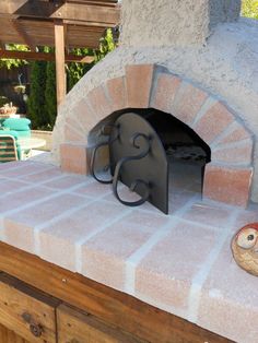 an outdoor pizza oven is shown in this image