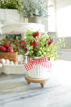 a vase filled with flowers sitting on top of a table next to an egg carton