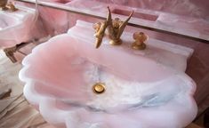 a bathroom sink made out of pink marble