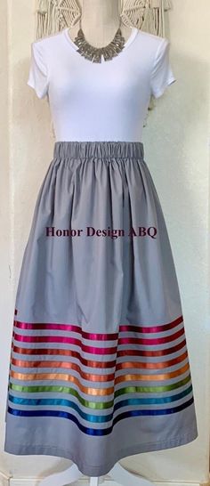 a dress on display with the name homo design abo written in red and blue