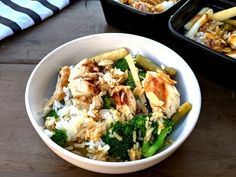 a bowl filled with rice, broccoli and chicken next to two pans of food