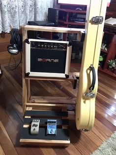 a guitar case sitting on top of a wooden stand