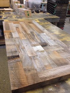 a table made out of wooden planks in a warehouse