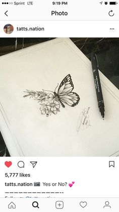 a drawing of a butterfly on top of a paper with a marker next to it