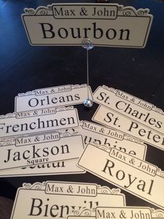 many name tags are hanging on a table with the names of different people in them