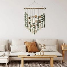 a living room with a white couch, coffee table and dream catcher hanging on the wall